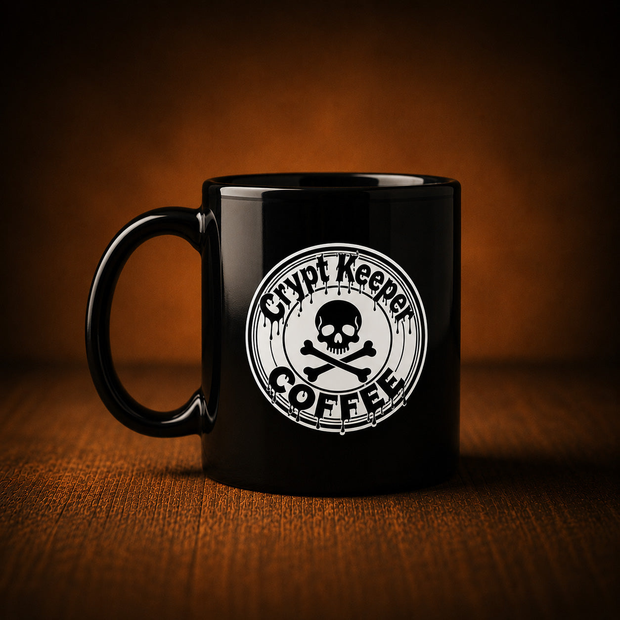 A glossy black ceramic coffee mug with a white circular skull-and-crossbones logo and the words 'Crypt Keeper Coffee' printed on the front, set on a wooden surface against a warm brown gradient background.